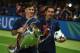 Barcelona's midfielder Xavi Hernandez (R) and Barcelona's Argentinian forward Lionel Messi celebrate with the trophy after the UEFA Champions League Final football match between Juventus and FC Barcelona at the Olympic Stadium in Berlin on June 6, 2015. FC Barcelona won the match 1-3. AFP PHOTO / PATRIK STOLLARZ (Photo credit should read PATRIK STOLLARZ/AFP/Getty Images)