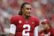 Alabama quarterback Jalen Hurts talks with teammates on the sideline during the second half of an NCAA college football game, Saturday, Nov. 18, 2017, in Tuscaloosa, Ala. (AP Photo/Brynn Anderson)