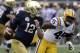 Notre Dame quarterback Ian Book (12) shambles for yardage past LSU linebacker Michael Divinity Jr. (45) during the first half of the Citrus Bowl NCAA college football game, Monday, Jan. 1, 2018, in Orlando, Fla. (AP Photo/John Raoux)