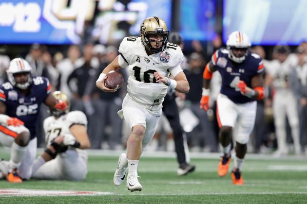 ATLANTA, GA - JANUARY 01:  McKenzie Milton #10 of the UCF Knights runs on his way to scoring a touchdown in the second quarter against the Auburn Tigers during the Chick-fil-A Peach Bowl at Mercedes-Benz Stadium on January 1, 2018 in Atlanta, Georgia.  (Photo by Streeter Lecka/Getty Images)