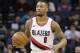 Portland Trail Blazers' Damian Lillard (0) brings the ball up the court against the Charlotte Hornets during the first half of an NBA basketball game in Charlotte, N.C., Saturday, Dec. 16, 2017. (AP Photo/Chuck Burton)