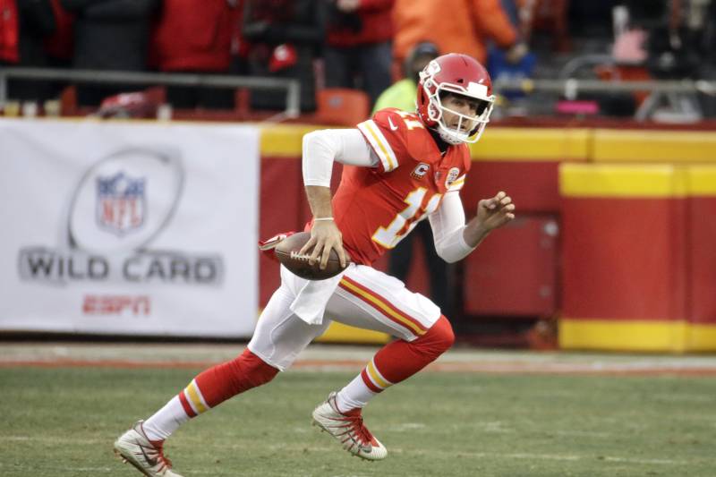 Kansas City Chiefs quarterback Alex Smith (11) carries the ball during the first half of an NFL wild-card playoff football game against the Tennessee Titans, in Kansas City, Mo., Saturday, Jan. 6, 2018. (AP Photo/Charlie Riedel)