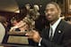 FILE - In this Dec. 13, 1997, file photo, Michigan's Charles Woodson poses with the Heisman Trophy after becoming the first primarily defensive player ever to take the honor at the Downtown Athletic Club in New York. Tyrann Mathieu's play for top-ranked LSU has spawned a grass roots Heisman Trophy campaign by LSU fans that includes a Tyrann Mathieu for Heisman Facebook page. His chances of joining Woodson to become the second defense-first player in the modern era of football to win the Heisman are probably pretty slim. (AP Photo/Adam Nadel, File)