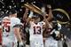 ATLANTA, GA - JANUARY 08: Tua Tagovailoa #13 of the Alabama Crimson Tide holds the trophy while celebrating with his team after defeating the Georgia Bulldogs in overtime to win the CFP National Championship presented by AT&T at Mercedes-Benz Stadium on January 8, 2018 in Atlanta, Georgia. (Photo by Mike Ehrmann/Getty Images)