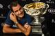 Switzerland's Roger Federer speaks next to the championship trophy during a press conference after his victory against Spain's Rafael Nadal in the men's singles final on day 14 of the Australian Open tennis tournament in Melbourne on January 30, 2017. / AFP / WILLIAM WEST / IMAGE RESTRICTED TO EDITORIAL USE - STRICTLY NO COMMERCIAL USE (Photo credit should read WILLIAM WEST/AFP/Getty Images)