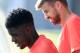 Barcelona's French defender Samuel Umtiti (L) and Barcelona's defender Gerard Pique arrive to a training session at the Sports Center FC Barcelona Joan Gamper in Sant Joan Despi, near Barcelona on August 19, 2016 / AFP / PAU BARRENA (Photo credit should read PAU BARRENA/AFP/Getty Images)