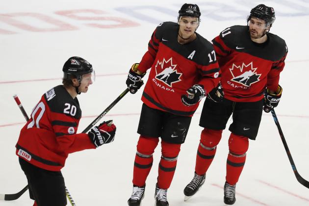 Canada's Matt Ellison, left, Rene Bourque, center, and Taylor Beck celebrate after scoring their team first goal during the Channel One Cup ice hockey match between Czech Republic and Canada in Moscow, Russia, on Friday, Dec. 15, 2017.(AP Photo/Pavel Golovkin)