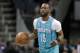 Charlotte Hornets' Kemba Walker (15) brings the ball up the court against the Oklahoma City Thunder during the first half of an NBA basketball game in Charlotte, N.C., Saturday, Jan. 13, 2018. (AP Photo/Chuck Burton)