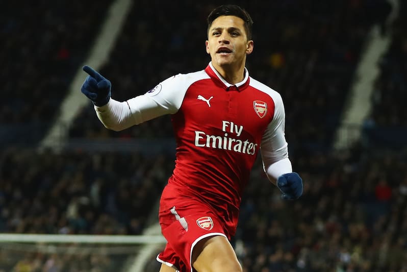 WEST BROMWICH, ENGLAND - DECEMBER 31: Alexis Sanchez of Arsenal celebrates as his free kick deflects off James McClean of West Bromwich Albion for their first goal during the Premier League match between West Bromwich Albion and Arsenal at The Hawthorns on December 31, 2017 in West Bromwich, England. (Photo by Michael Steele/Getty Images)