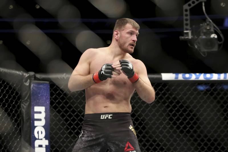 Stipe Miocic in action against Francis Ngannou during a heavyweight championship mixed martial arts bout at UFC 220, Sunday, Jan. 21, 2018, in Boston. Miocic retained his title via unanimous decision. (AP Photo/Gregory Payan)