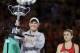 Denmark's Caroline Wozniacki, left, holds her trophy after defeating Romania's Simona Halep, right, in the women's singles final at the Australian Open tennis championships in Melbourne, Australia, Saturday, Jan. 27, 2018. (AP Photo/Dita Alangkara)