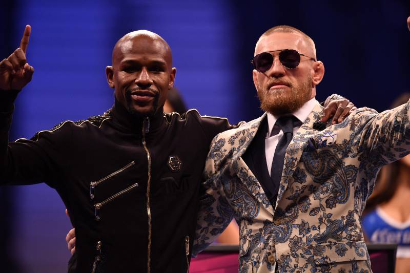 LAS VEGAS, NV - AUGUST 25: (L-R) Floyd Mayweather Jr. and Conor McGregor pose for pictures during a news conference after Mayweather's 10th-round TKO victory in their super welterweight boxing match on August 26, 2017 at T-Mobile Arena in Las Vegas, Nevada. (Photo by Jeff Bottari/Zuffa LLC/Zuffa LLC via Getty Images)