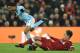 Manchester City's English midfielder Raheem Sterling (L) goes down as Liverpool's Brazilian midfielder Roberto Firmino (R) attempts a tackle during the English Premier League football match between Liverpool and Manchester City at Anfield in Liverpool, north west England on January 14, 2018. / AFP PHOTO / Oli SCARFF / RESTRICTED TO EDITORIAL USE. No use with unauthorized audio, video, data, fixture lists, club/league logos or 'live' services. Online in-match use limited to 75 images, no video emulation. No use in betting, games or single club/league/player publications. / (Photo credit should read OLI SCARFF/AFP/Getty Images)