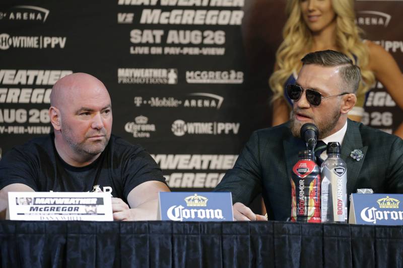 Conor McGregor, right, speaks during news conference Wednesday, Aug. 23, 2017, in Las Vegas. McGregor is scheduled to fight Floyd Mayweather Jr. in a boxing match Saturday in Las Vegas. Dana White is on the left. (AP Photo/John Locher)