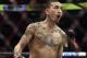 Max Holloway jogs around the ring as he waits for Jose Aldo of Brazil to arrive for their UFC 218 featherweight mixed martial arts bout, early Sunday, Dec. 3, 2017, in Detroit. Holloway defeated Aldo by third-round TKO. (AP Photo/Jose Juarez)