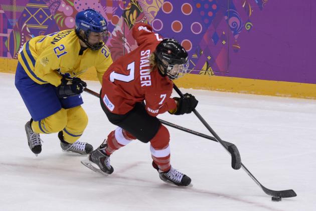 Sweden's Erica Uden Johansson (L) vies with Switzerland's Lara Stalder during the Women's Ice Hockey Bronze Medal Game Switzerland vs Sweden at the Bolshoy Ice Dome during the Sochi Winter Olympics on February 20, 2014.   AFP PHOTO / ALEXANDER NEMENOV        (Photo credit should read ALEXANDER NEMENOV/AFP/Getty Images)