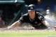 FILE - In this Aug. 24, 2017, file photo, Miami Marlins' J.T. Realmuto dives into home plate with a with a two-run inside the park home run against the Philadelphia Phillies during the sixth inning of a baseball game, in Philadelphia, Pa. A person familiar with the situation says Miami Marlins catcher J.T. Realmuto has requested a trade in the wake of the team’s latest payroll purge. The person confirmed the request to The Associated Press on condition of anonymity Monday, Dec. 18, 2017, because the Marlins didn’t comment. (AP Photo/Rich Schultz, File)