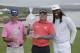 From left, Kevin Streelman, Ted Potter Jr. and Larry Fitzgerald pose with their trophies on the 18th green of the Pebble Beach Golf Links after the final round of the AT&T Pebble Beach National Pro-Am golf tournament Sunday, Feb. 11, 2018, in Pebble Beach, Calif. Potter Jr. won the tournament and Streelman and Fitzgerald won the pro-am title. (AP Photo/Eric Risberg)