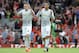Manchester United's Phil Jones, left, and Manchester United's Chris Smalling applause he audience after during the English Premier League soccer match between Liverpool and Manchester United at Anfield, Liverpool, England, Saturday, Oct. 14, 2017. (AP Photo/Rui Vieira)