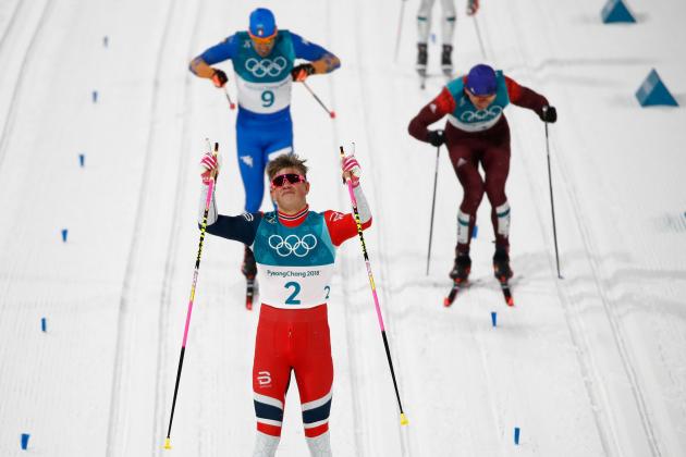 Norway's Johannes Hoesflot Klaebo celebrates crossing the finish line to win gold followed by Italy's Federico Pellegrino (L back) taking silver and Russia's Alexander Bolshunov winning bronze during the men's cross-country individual sprint classic final at the Alpensia cross country ski centre during the Pyeongchang 2018 Winter Olympic Games on February 13, 2018 in Pyeongchang. / AFP PHOTO / Odd ANDERSEN (Photo credit should read ODD ANDERSEN/AFP/Getty Images)
