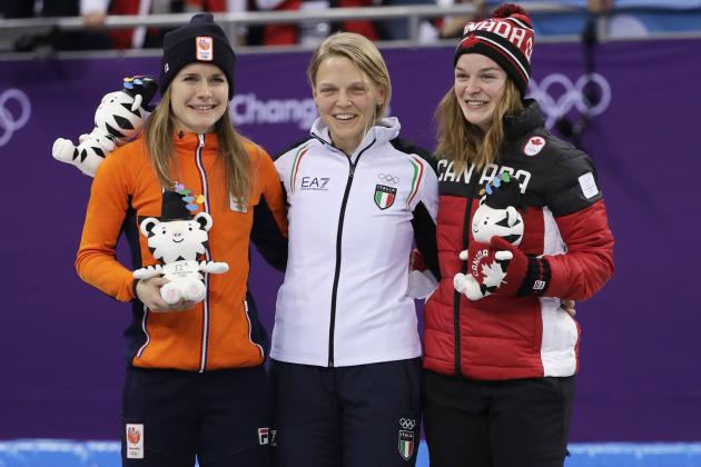 Race winner Arianna Fontana, centre, of Italy, stands with second placed Yara van Kerkhof, left, of the Netherlands and third placed Kim Boutin of Canada on the podium during the venue ceremony after ladies' 500 meters short track speedskating final in the Gangneung Ice Arena at the 2018 Winter Olympics in Gangneung, South Korea, Tuesday, Feb. 13, 2018. (AP Photo/David J. Phillip)