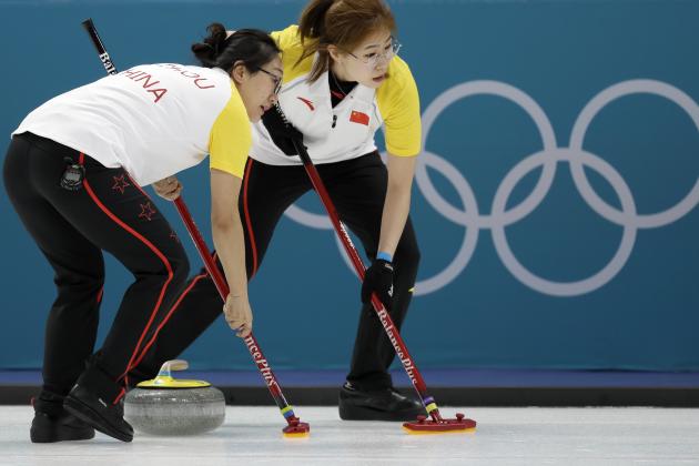 China's Zhou Yan, left, and Liu Jinli sweeps the ice during their women's curling match against Switzerland at the 2018 Winter Olympics in Gangneung, South Korea, Wednesday, Feb. 14, 2018. (AP Photo/Aaron Favila)