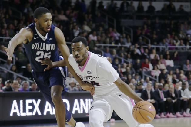 Providence guard Kyron Cartwright (24) drives the lane against Villanova guard Mikal Bridges (25) during the first half of their NCAA college basketball game Wednesday, Feb. 14, 2018, in Providence, R.I. (AP Photo/Stephan Savoia)