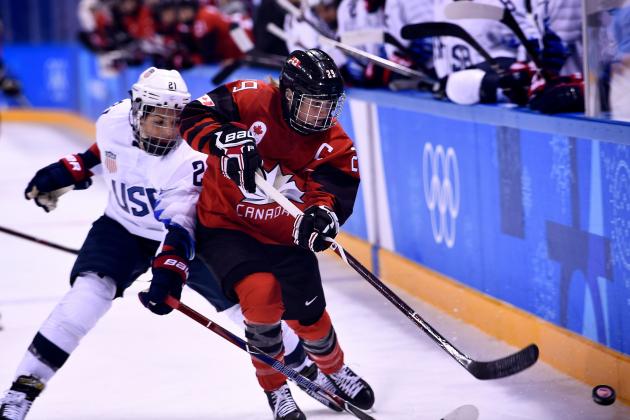 USA's Hilary Knight (L) and Canada's Marie-Philip Poulin fight for the puck in the women's preliminary round ice hockey match between the US and Canada during the Pyeongchang 2018 Winter Olympic Games at the Kwandong Hockey Centre in Gangneung on February 15, 2018.   / AFP PHOTO / Brendan Smialowski        (Photo credit should read BRENDAN SMIALOWSKI/AFP/Getty Images)