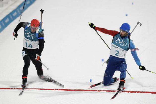 Simon Schempp, of Germany, left, and Martin Fourcade, of France, right, race across the finish line during the men's 15-kilometer mass start biathlon at the 2018 Winter Olympics in Pyeongchang, South Korea, Sunday, Feb. 18, 2018. (AP Photo/Andrew Medichini)