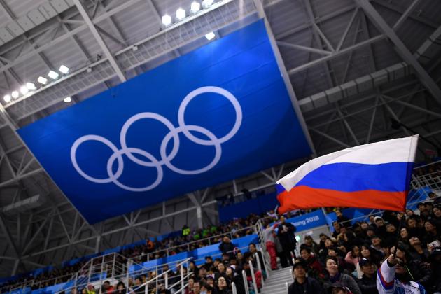 A spectator waves the Russia flag during the men's preliminary round ice hockey match between the Olympic Athletes from Russia and Slovenia during the Pyeongchang 2018 Winter Olympic Games at the Gangneung Hockey Centre in Gangneung on February 16, 2018. / AFP PHOTO / Brendan Smialowski (Photo credit should read BRENDAN SMIALOWSKI/AFP/Getty Images)