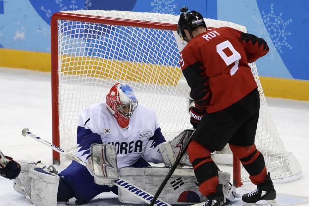 Goalie Matt Dalton (1), of South Korea, deflects the puck as Derek Roy (9), of Canada, tries to shoot during the third period of the preliminary round of the men's hockey game at the 2018 Winter Olympics in Gangneung, South Korea, Sunday, Feb. 18, 2018. (AP Photo/Matt Slocum)