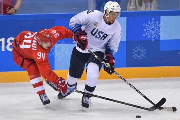 Russia's Alexander Barabanov and US Jordan Greenway vie for the puck in the men's ice hockey preliminary round group B game between the Olympic Athletes from Russia and the United States during the Pyeongchang 2018 Winter Olympic Games at the Gangneung Hockey Centre in Gangneung on February 17, 2018. / AFP PHOTO / Ed JONES        (Photo credit should read ED JONES/AFP/Getty Images)