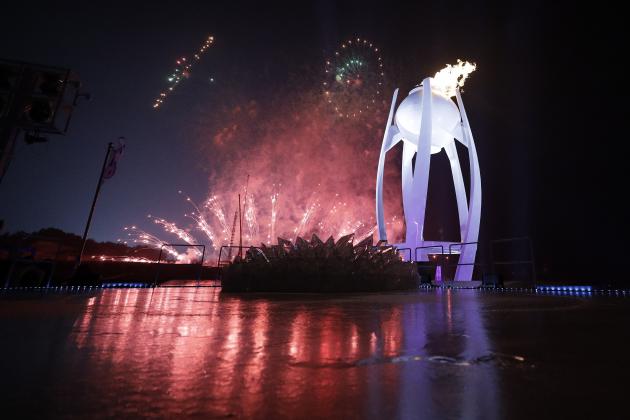 Fireworks explode behind the Olympic flame during the opening ceremony of the 2018 Winter Olympics in Pyeongchang, South Korea, Friday, Feb. 9, 2018. (AP Photo/David J. Phillip,Pool)