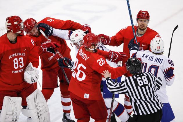 GANGNEUNG, SOUTH KOREA - FEBRUARY 21:  Olympic Athlete from Russia GAVRIKOV Vladislav (#4)  and Norway's Ludvig Hoff (#27) fight for the puck in their men's quarterfinal ice hockey match during the 2018 Winter Olympic Games, at the Gangneung Hockey Centre.  (Photo by XIN LI/Getty Images)