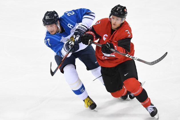 Finland's Petri Kontiola clashes with Canada's Karl Stollery in the men's quarter-final ice hockey match between Finland and Canada during the Pyeongchang 2018 Winter Olympic Games at the Gangneung Hockey Centre in Gangneung on February 21, 2018.   / AFP PHOTO / Kirill KUDRYAVTSEV        (Photo credit should read KIRILL KUDRYAVTSEV/AFP/Getty Images)