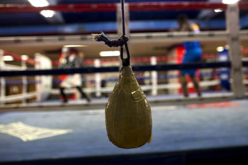 In this Wednesday, April 20, 2016 photo, boxers work out inside a ring during a training session at El Rayo boxing gym in Madrid, Spain. At 84, Manolo del Rio is something of a legend in Spanish boxing circles, having spent more than 65 years training some of the country's best fighters and pledging to keep on going until he drops, he spends 12-14 hours a day at the gym in a working class neighborhood of Madrid. (AP Photo/Francisco Seco)
