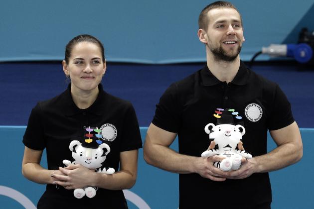 FILE - In this Feb. 13, 2018 file photo, Russian athletes Anastasia Bryzgalova, left, and Alexander Krushelnitsky smile as they win bronze medal during the venue ceremony for the mixed doubles curling match at the 2018 Winter Olympics in Gangneung, South Korea. Russian curlers say a coach on their team told them that Krushelnitsky tested positive for a banned substance at the Pyeongchang Olympics. (AP Photo/Aaron Favila, File)