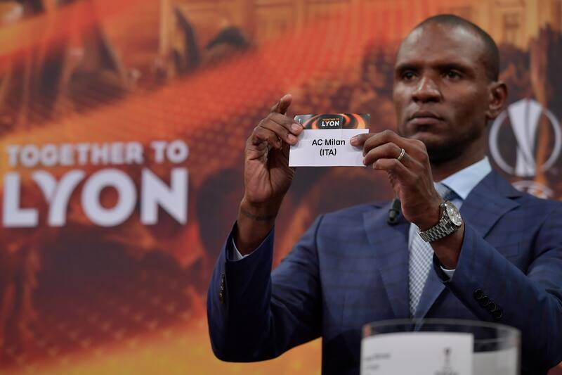 French former international Eric Abidal shows the slip of AC Milan during the draw for the round of 32 of the UEFA Europa League football tournament at the UEFA headquarters in Nyon on December 11, 2017. / AFP PHOTO / Fabrice COFFRINI (Photo credit should read FABRICE COFFRINI/AFP/Getty Images)