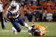 FILE - In this Sunday, Nov. 12, 2017, file photo, New England Patriots tight end Martellus Bennett (88) is tripped up by Denver Broncos free safety Darian Stewart (26) during the first half of an NFL football game in Denver. Bennett is still coming to terms with how his Green Bay tenure ended. But he says being back in familiar surroundings is helping him to deal with it. (AP Photo/Jack Dempsey, File)