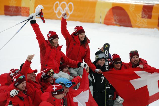 Switzerland's Michelle Gisin, left, gold, and Switzerland's Wendy Holdener, bronze, are hoisted aloft by team members after the flower ceremony for the women's combined slalom at the 2018 Winter Olympics in Jeongseon, South Korea, Thursday, Feb. 22, 2018. (AP Photo/Christophe Ena)