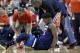 Minnesota Timberwolves guard Jimmy Butler (23) reacts to a knee injury on the court as Houston Rockets guard Chris Paul (3) and team trainers hover over him during the second half of an NBA basketball game Friday, Feb. 23, 2018, in Houston. (AP Photo/Michael Wyke)