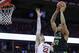 Michigan State's Miles Bridges, right, shoots over Wisconsin's Ethan Happ during the first half of an NCAA college basketball game Sunday, Feb. 25, 2018, in Madison, Wis. (AP Photo/Andy Manis)