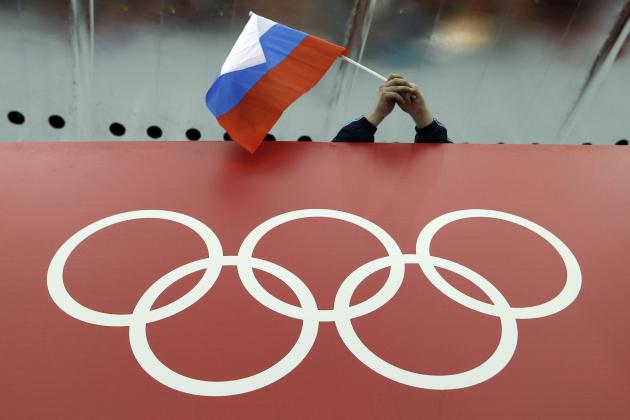 FILE - In this Feb. 18, 2014 file photo, a Russian skating fan holds the country's national flag over the Olympic rings at Adler Arena Skating Center during the 2014 Winter Olympics in Sochi, Russia. The Court of Arbitration for Sport has received 20 more appeals from Russian athletes against Olympic doping bans, taking the total to 42. The athletes' appeals will be fast-tracked. CAS said those cases will be heard together in the week beginning Jan. 22, and it expects verdicts will be issued by Jan. 31. (AP Photo/David J. Phillip, File)