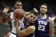 TCU guard Kenrich Williams, front, rebounds in front of Kansas State forward Levi Stockard III (34) and TCU forward Ahmed Hamdy-Mohamed (23) during the first half of an NCAA college basketball game in quarterfinals of the Big 12 conference tournament in Kansas City, Mo., Thursday, March 8, 2018. (AP Photo/Orlin Wagner)
