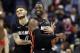 Miami Heat guard Tyler Johnson, left, reacts with guard Dwyane Wade during the overtime period an NBA basketball game against the Washington Wizards, Tuesday, March 6, 2018, in Washington. The Wizards won 117-113. (AP Photo/Alex Brandon)