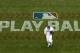 San Diego Padres left fielder Allen Cordoba passes a logo for Play Ball, an initiative from Major League Baseball and USA Baseball, during the fifth inning of a baseball game against the Colorado Rockies Saturday, June 3, 2017, in San Diego. (AP Photo/Gregory Bull)