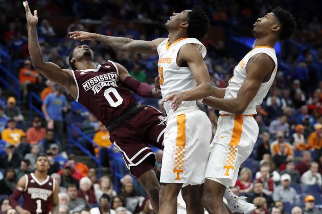 Mississippi State's Nick Weatherspoon (0) goes up for a layup past Tennessee's Jordan Bowden and Kyle Alexander, right, during the second half of an NCAA college basketball game in the quarterfinals of the Southeastern Conference tournament, Friday, March 9, 2018, in St. Louis. Weatherspoon was injured on the play and taken off on a stretcher. (AP Photo/Jeff Roberson)