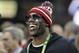 Terrell Owens smiles before the NCAA college football playoff championship game between Georgia and Alabama, Monday, Jan. 8, 2018, in Atlanta. (AP Photo/David J. Phillip)