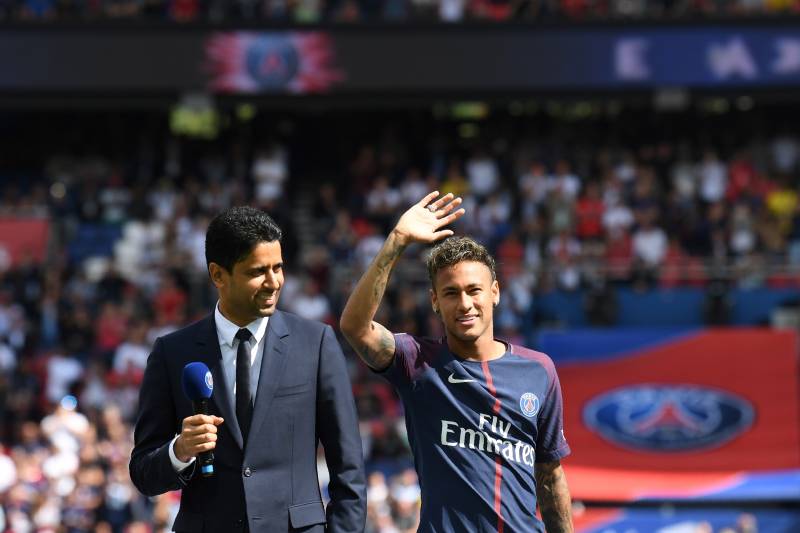 Paris Saint-Germain's Brazilian forward Neymar (C), flanked by Paris Saint Germain's (PSG) Qatari president Nasser Al-Khelaifi (L), waves to the crowd during his presentation to the fans at the Parc des Princes stadium in Paris, on August 5, 2017.
Brazil superstar Neymar will watch from the stands as Paris Saint-Germain open their season on August 5, 2017, but the French club have already clawed back around a million euros on their world record investment. Neymar, who signed from Barcelona for a mind-boggling 222 million euros ($264 million), is presented to the PSG support prior to his new team's first game of the Ligue 1 campaign against promoted Amiens.
/ AFP PHOTO / ALAIN JOCARD (Photo credit should read ALAIN JOCARD/AFP/Getty Images)