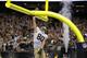 New Orleans Saints tight end Jimmy Graham (80) slam dunks over the goalpost after scoring on a touchdown reception in the second half of an NFL football game against the Arizona Cardinals in New Orleans, Sunday, Sept. 22, 2013. (AP Photo/Bill Haber)